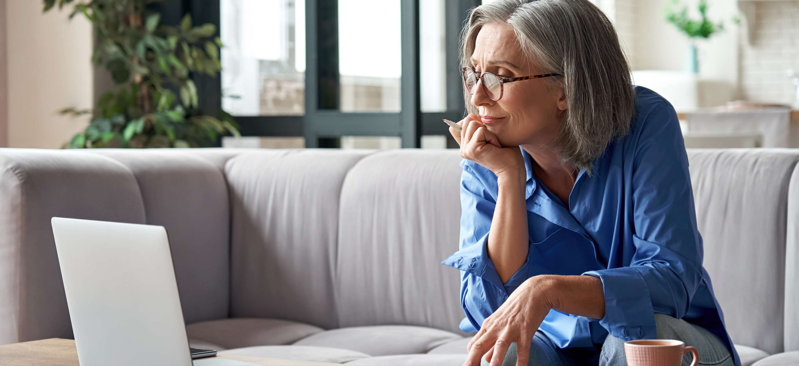 Senior mature older woman watching business training, online webinar on laptop computer remote working or social distance learning from home. 60s businesswoman video conference calling in virtual chat
